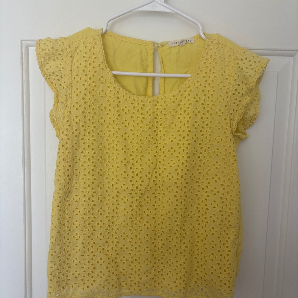 copper key yellow blouse